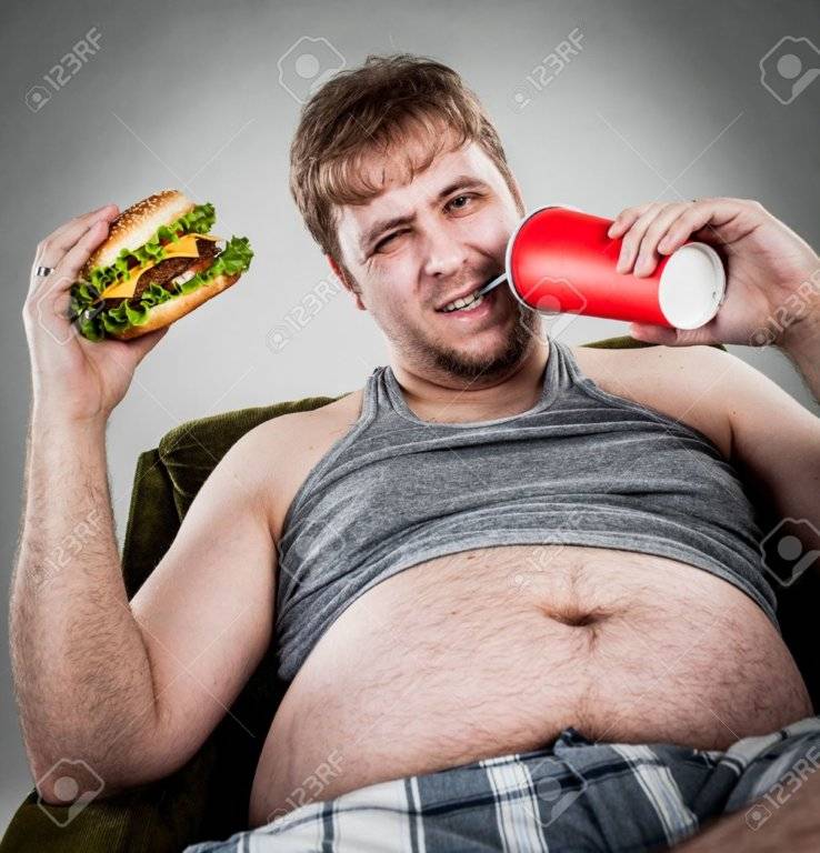 14569667-fat-man-eating-hamburger-seated-on-armchair-Stock-Photo-overweight.jpg