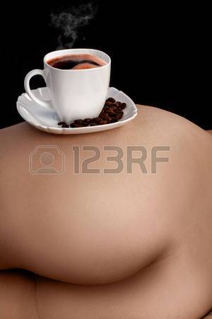 27278805-vertical-picture-of-coffee-in-cup-on-woman-s-***-in-studio.jpg