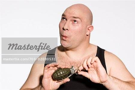 700-02080531em-man-about-to-pull-pin-from-hand-grenade-stock-photo.jpg