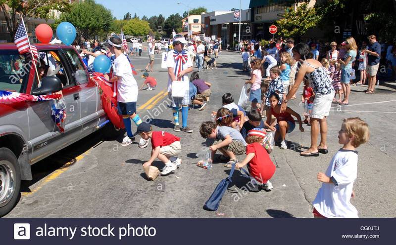 kids-scramble-in-the-street-for-candy-thrown-by-participants-in-the-CG0JTJ.jpg