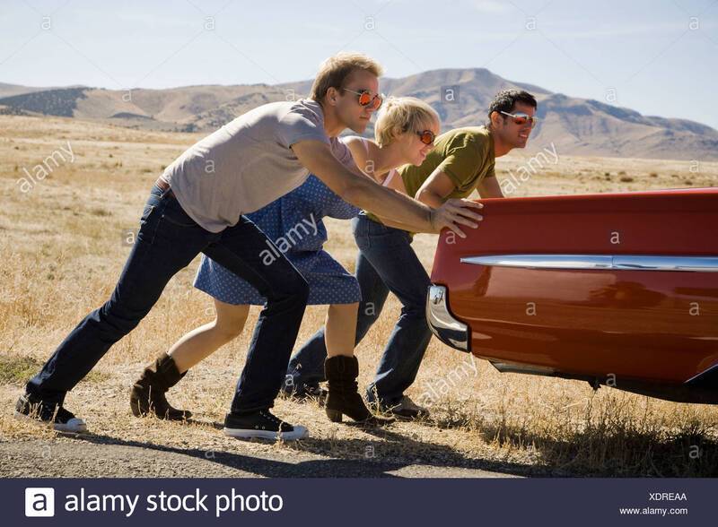 people-pushing-a-car-down-the-road-XDREAA.jpg