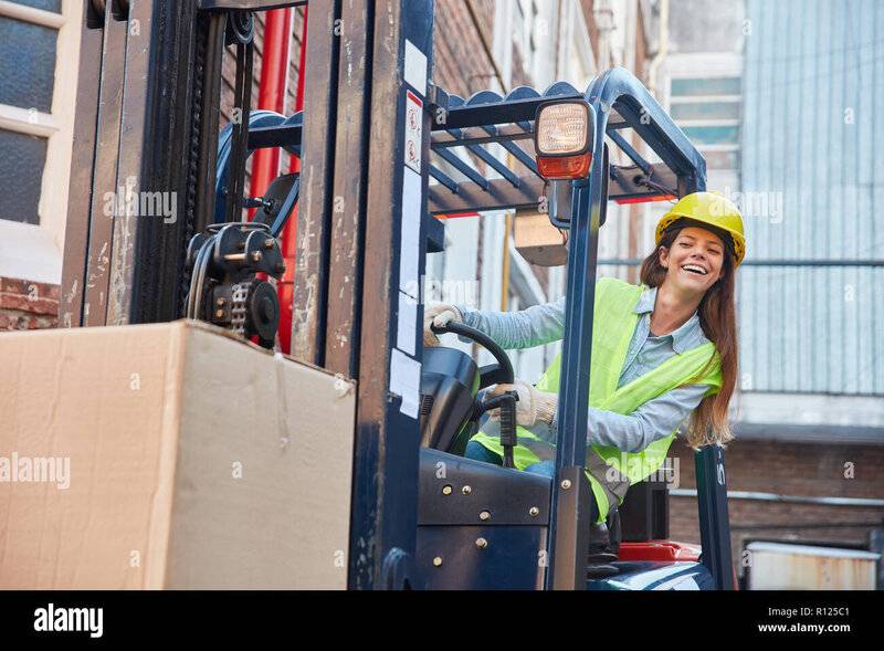 young-woman-in-logistics-training-to-forklift-driver-on-the-forklift-R125C1.jpg